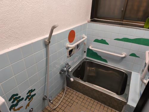 a sink in a bathroom with blue tiles at 4 minute walk from the station,USJ33min KIX48min Namba10min, Convenience store, coin laundry, public bath, all 1 minute walk Kitakagaya INN OSAKA , 6 ppl, Near Namba to 10min,駅近徒歩4分一軒家貸切北加賀屋駅からなんば駅まで10分 in Osaka