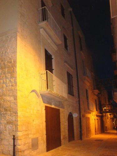 a building with a balcony on the side of it at B&B re apartments Palazzo Muscati in Molfetta