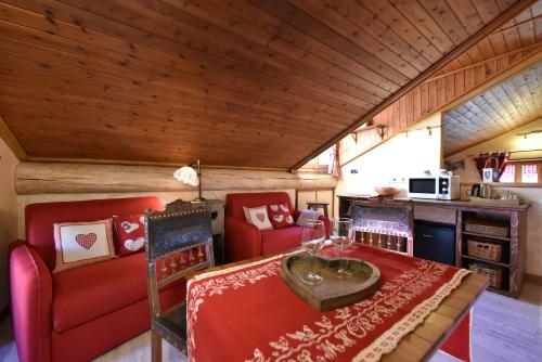 a living room with a table and two chairs at L'Ancien Paquier Chambre D'Hotes in Valtournenche