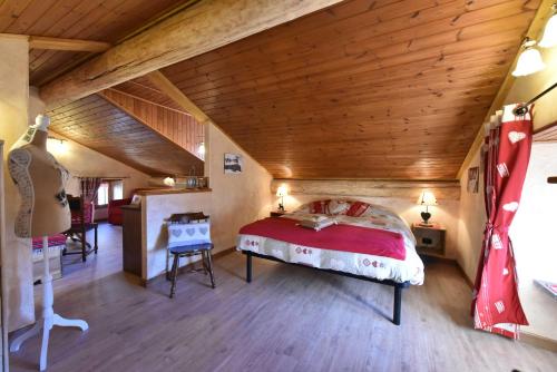 a bedroom with a large bed in a attic at L'Ancien Paquier Chambre D'Hotes in Valtournenche