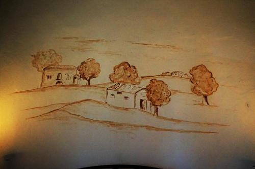 a drawing of a house and trees on a wall at Agriturismo Antico Borgo Poggitazzi in Loro Ciuffenna