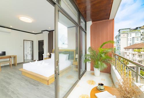 a bedroom with a bed and a balcony at Peaceful 2 Hotel in Vientiane