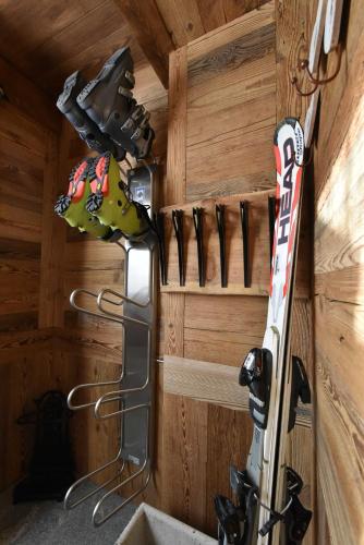 a group of skis hanging on a wall at L'Ancien Paquier Chambre D'Hotes in Valtournenche