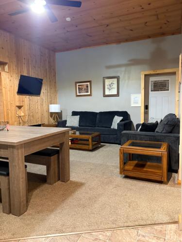 a living room with a couch and a table at Pool Table & Hot tub - closest place to the GAP trail in Ohiopyle in Ohiopyle