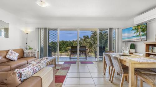 a living room with a couch and a table at The Calm At Moreton View in Woorim