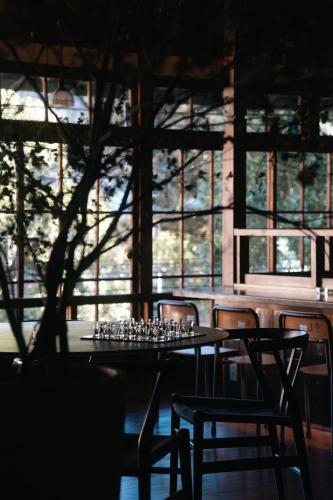 a table and chairs with wine glasses on it at RoheN HAKONEYUMOTO in Hakone