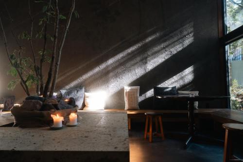 a dark room with candles and a couch and a table at RoheN HAKONEYUMOTO in Hakone