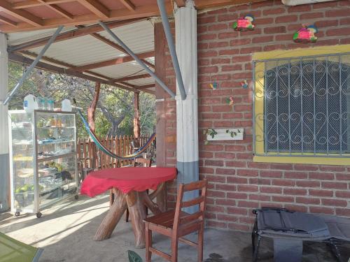 a patio with a table and chairs under awning at Beach cabin ometepe in Altagracia