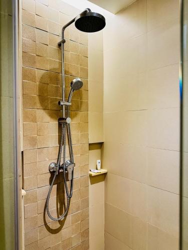 a shower with a shower head in a bathroom at Ferra Hotel and Garden Suites in Boracay