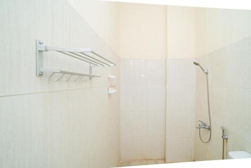 a bathroom with a shower and a sink at RedDoorz near Universitas Merdeka Malang 2 in Malang