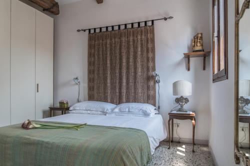 a bedroom with a white bed and a window at Three Terraces in Venice