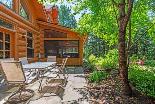 a patio with a table and chairs in front of a house at Fiddler Lake Resort - Bear 22 in Mille-Isles