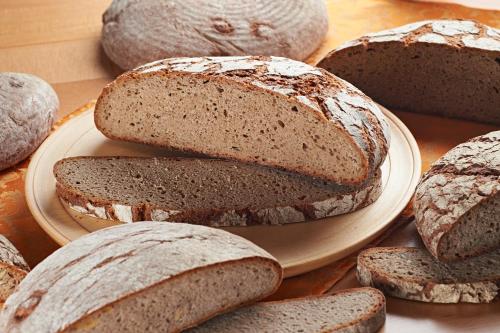 a group of breads on a plate on a table at Apartments Organic Tourist Farm Gradišnik in Prevalje