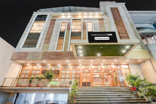 a building with a sign on the front of it at Townhouse Oak Dehradun Court Formerly GK Residency in Dehradun