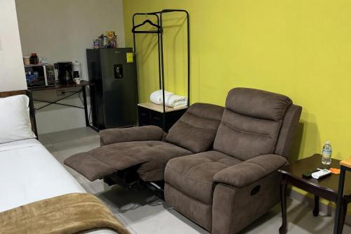 a living room with a couch and a chair at Habitación Chero Platinum in Comalcalco