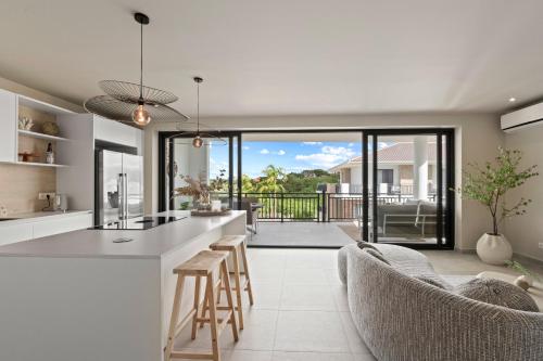a kitchen and living room with a view of a patio at Luxury Two-Bedroom Apartments at Blue Bay The Breeze in Dorp Sint Michiel