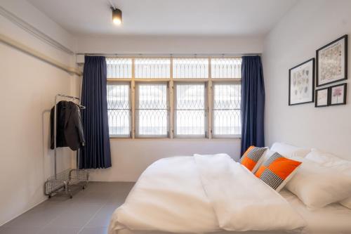 a bedroom with a white bed and a large window at House - 5 bedrooms only 6mins walk to MRT Rama 9 in Bangkok