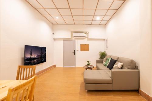 a living room with a couch and a table at House - 5 bedrooms only 6mins walk to MRT Rama 9 in Bangkok