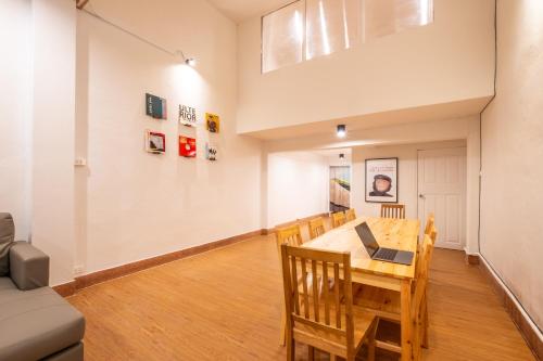 a dining room and living room with a table and chairs at House - 5 bedrooms only 6mins walk to MRT Rama 9 in Bangkok