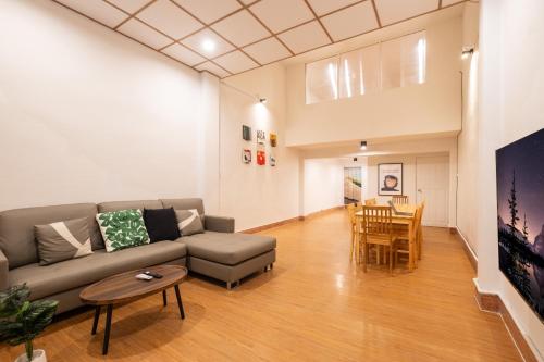 a living room with a couch and a table at House - 5 bedrooms only 6mins walk to MRT Rama 9 in Bangkok