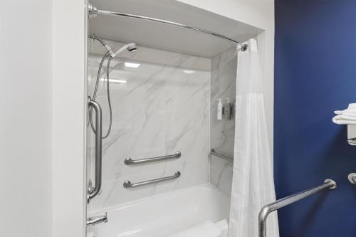 a bathroom with a shower with a glass door at Spark by Hilton Abingdon I-81 near Fairgrounds in Abingdon