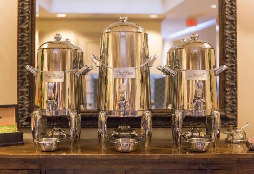a group of three gold kettles on a counter at Harbourview Inn in Charleston