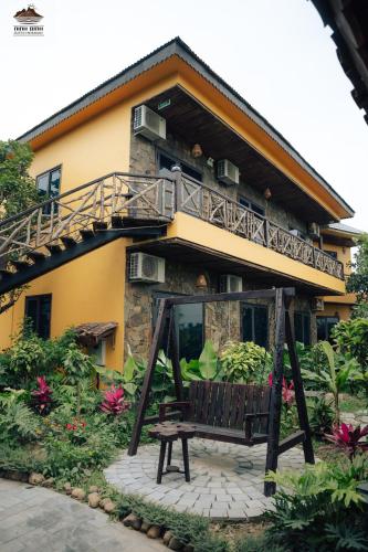 a house with a bench in front of it at Trang An Ninh Binh Rustic Hideaway in Ninh Binh