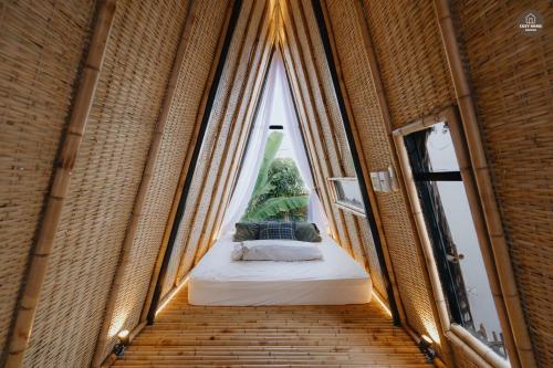 a room with a window with a bed in it at mango house, hide out Can Tho in Ấp Bình Thương