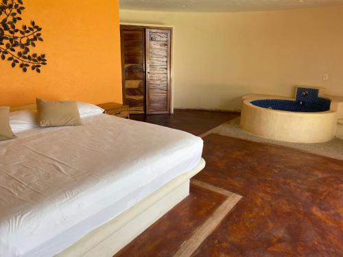 a bedroom with a bed and a bath tub at Laguinn Hotel Acapulco in Acapulco