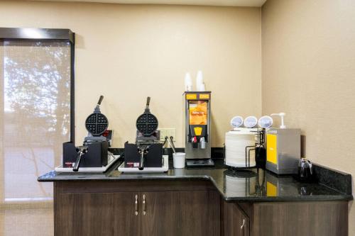 a counter in a room with two machines on it at Comfort Inn Pensacola - University Area in Pensacola