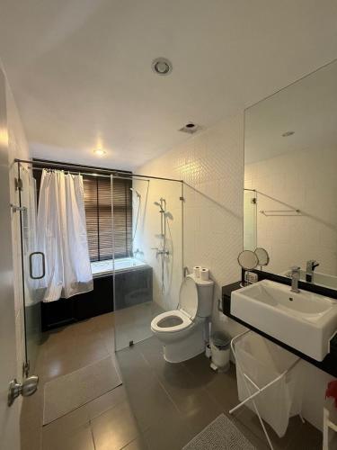 a bathroom with a toilet and a sink and a shower at Big Apartament with two bedrooms Karon in Phuket