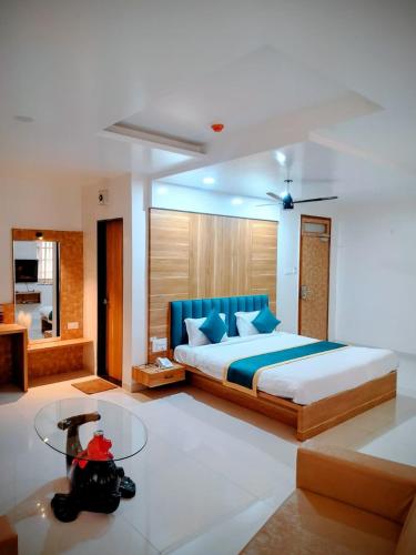 a bedroom with a bed with a camera in it at Hotel Lotus Suites in Miraj
