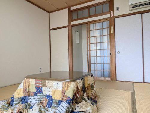 a room with a table on top of a couch at Amanohashidate Youth Hostel in Miyazu