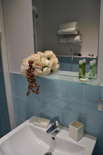 a bathroom with a sink and a mirror at Hotel Sant'Anna in Turin