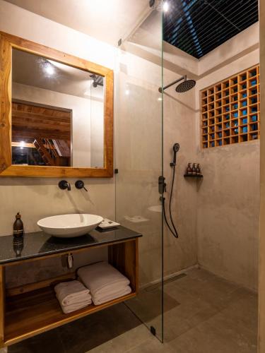 a bathroom with a sink and a shower at Ceylon Canopy in Hiriketiya