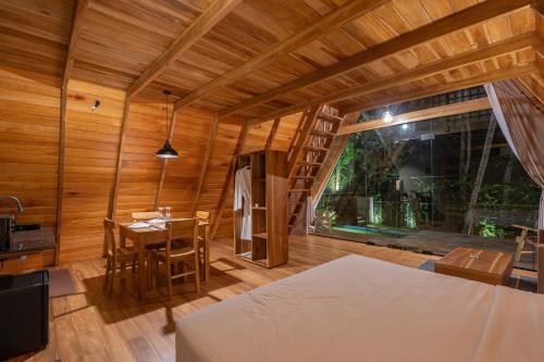 a room with a bed and a table and a ladder at Ceylon Canopy in Hiriketiya