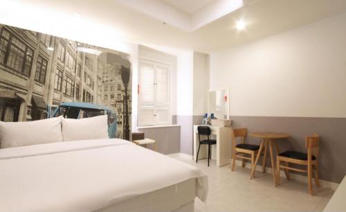a bedroom with a bed and a table and chairs at If Business Hotel in Changwon