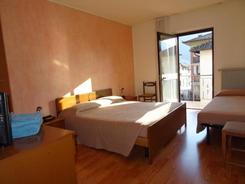 Postel nebo postele na pokoji v ubytování Hotel Galles