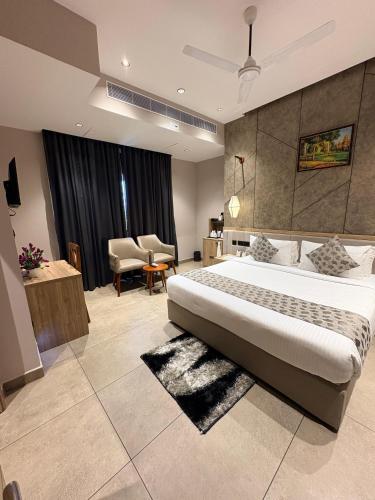 a bedroom with a large bed and a living room at Beeza Clubhouse in Kottayam