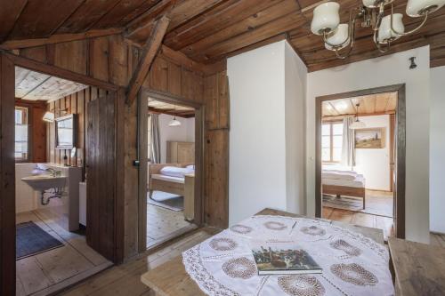 a bedroom with wooden walls and a bed in a room at Haus Grundlseeblick in Bräuhof
