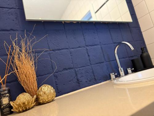 a bathroom with a sink and a blue wall at Ferienwohnung Alva Hinterzarten in Hinterzarten