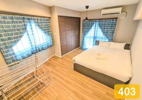 a bedroom with a bed in a room at Chateau Sunrise in Tokyo