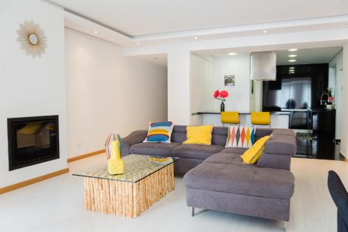 a living room with a couch and a table at Apartamento Vista Mar in Olhão