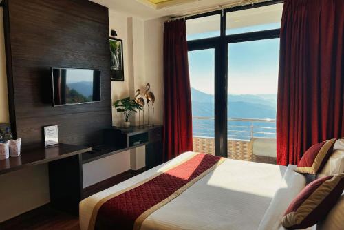 a hotel room with a bed and a large window at Hotel Ravine Palace in Lansdowne