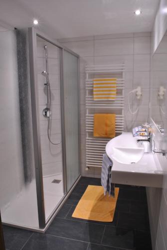 a bathroom with a sink and a shower at Apart Tyrolis in Sölden