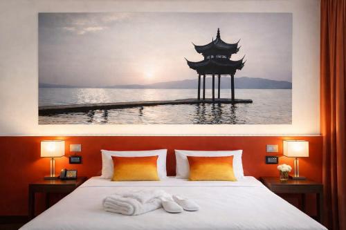 a bedroom with a bed with two towels on it at Amatì Design Hotel in Zola Predosa