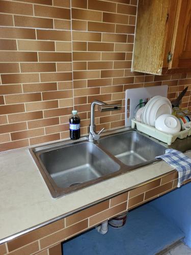 a kitchen counter with a sink in a kitchen at Enchanted Guest House & Hostel in Ocho Rios