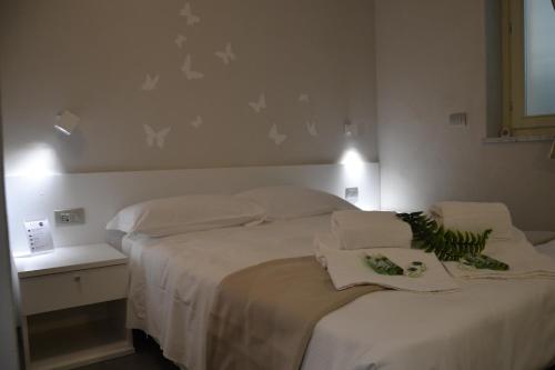 a bedroom with a large bed with white sheets at Hotel Sant'Anna in Turin