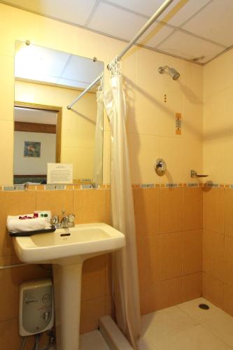 a bathroom with a sink and a shower at Silom Avenue Inn in Bangkok