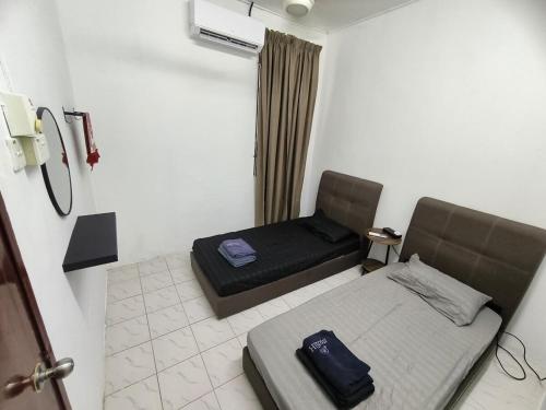 a small room with a bed and a window at Homestay Idora PD in Port Dickson